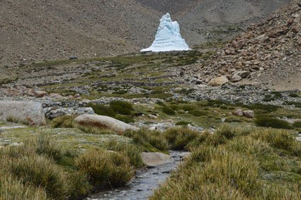 Ice stupa in Himalayan landscape.