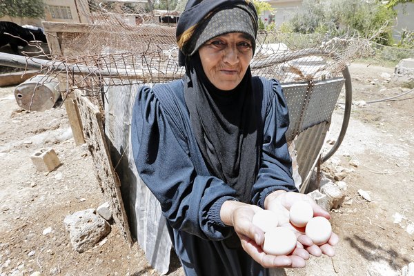 Old woman with eggs in her hand.