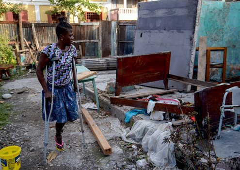 Marie Ange from Haiti standing in front of the ruins of her house in the wake of Hurricane Matthew. The new app can provide those helping after a disaster with practical advice.